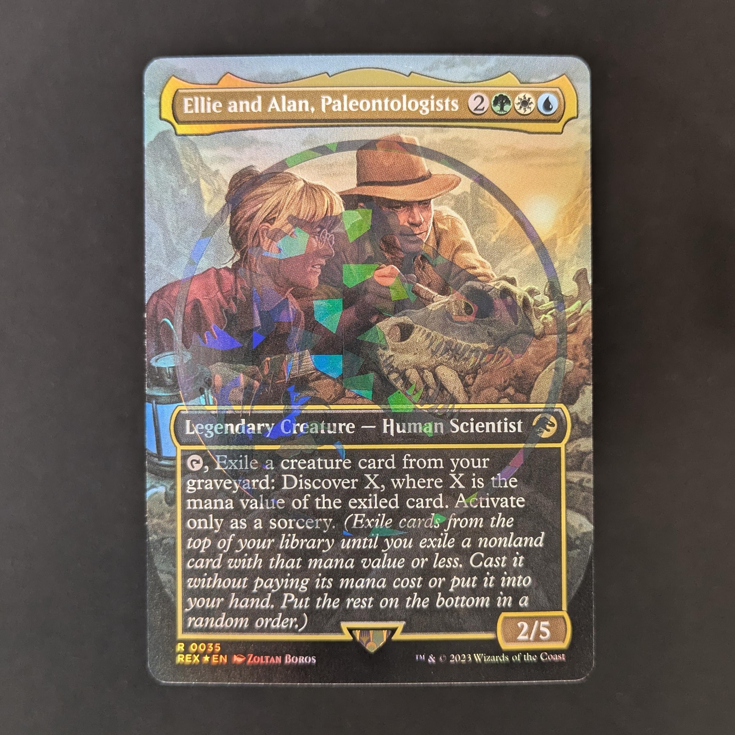 MTG Singles - [FOIL] Ellie and Alan, Paleontologists (Emblem Foil) - Universes Beyond: Jurassic World Collection - NM - 